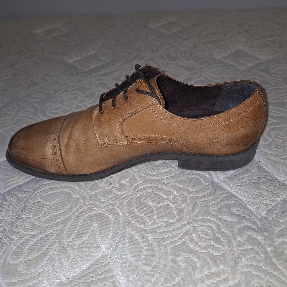 A pair of Cole Haan Oxfords in a men's size 12M. Pre-loved in good condition.